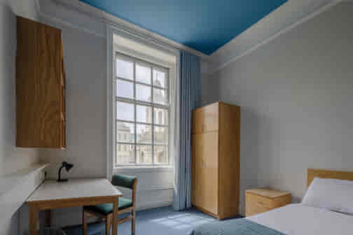 heritage single room with bed and window in trinity college dublin