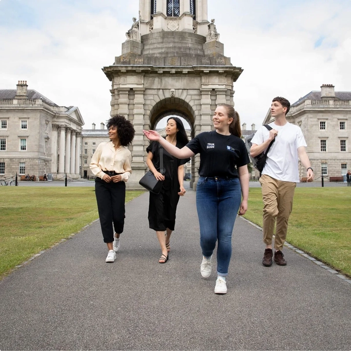 tour guide showing visitors around trinity college dublin