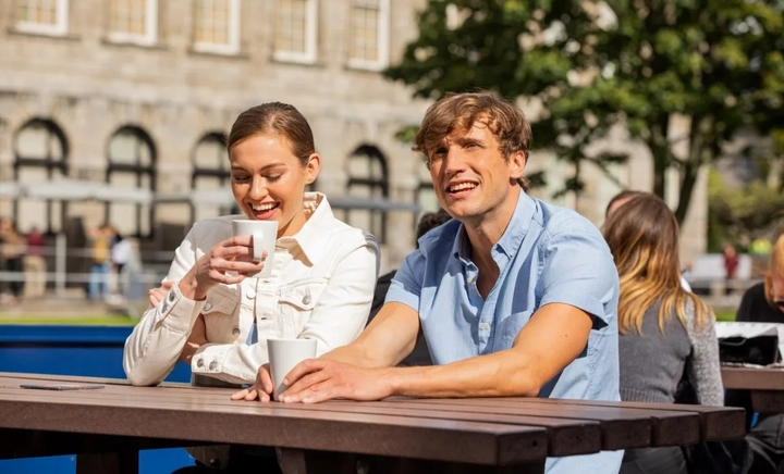 two people sitting with coffee cups at the perch cafe in trinity college dublin