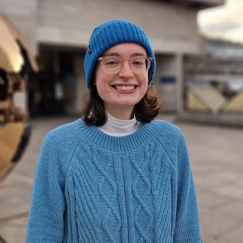 woman in blue hat and jumper
