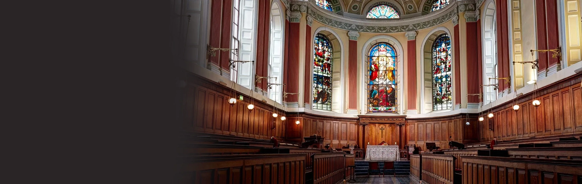 trinity chapel with stained glass windows and wood panelling