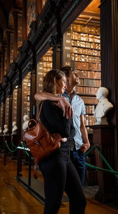 couple standing close together in long room trinity college dublin