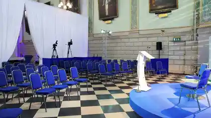 raised platform with chairs arranged in trinity college exam hall