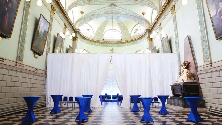 white divider in a room with ornate ceilings and blue tables