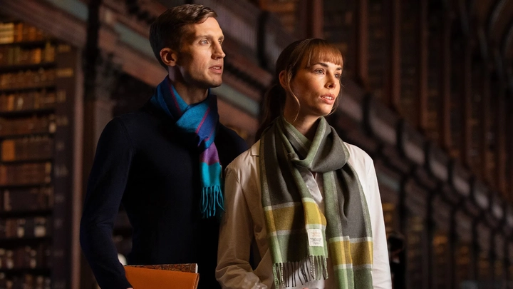 two people in scarves looking to the left