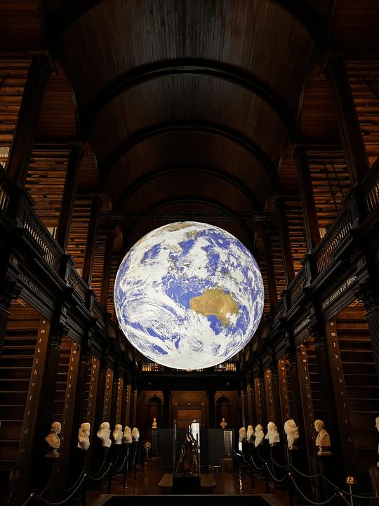 gaia hanging above sculptures in the old library