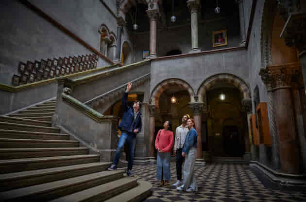 A tour guide with a group in the Museum Building in Trinity